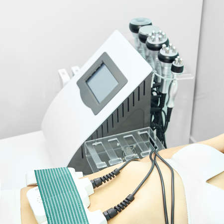 Laser lipo equipment. Cosmetic fat reduce treatment. Woman in medicine salon. Anti cellulite procedure.の写真素材