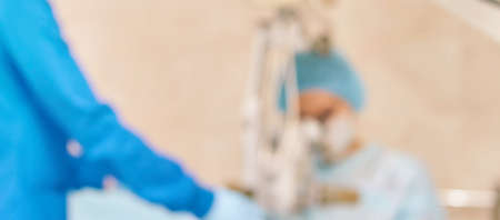 Ophthalmology laser microscope operation. Clinic room with doctor and parient. Blur background. Unfocus, selective focus.の写真素材