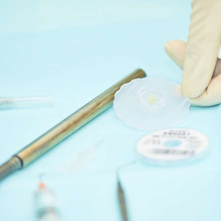 Ophthalmology laser microscope operation. Clinic room with doctor and parient. Gloves and medicine tools.の写真素材