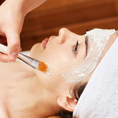 chemic facial peel mask. Cosmetology acne treatment. Young girl at medical spa salon. Brush. Face...