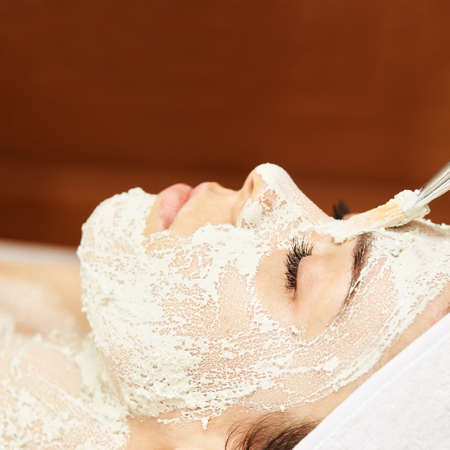 chemic facial peel mask. Cosmetology acne treatment. Young girl at medical spa salon. Brush. Face fruit acid. Sensitive peeling.の写真素材
