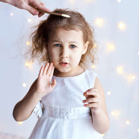 Stop denied gesture. Little cute girl sale portrait. Hairstylist comb. Photography of luxury female child. Unhappy sad emotion. Fresh person face. Kid eyes. Look at camera.の写真素材