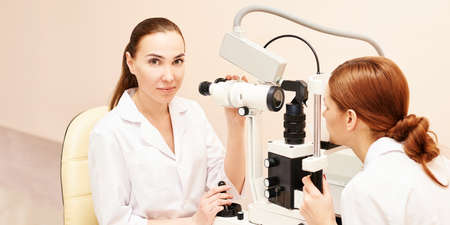 ophthalmologist doctor in exam optician laboratory with female patient. Eye care medical diagnostic....
