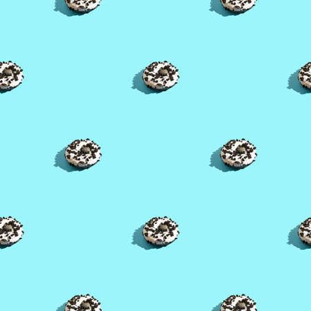 doughnut seamless pattern. White and black color. Tasty unhealthy food. Blue background. Many donuts with shadow. Chocolate bake snack. One sizeの写真素材
