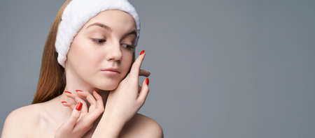 Young pretty woman studio portrait. Cosmetology concept. Esthetic woman face. Skin care dermatology beauty contour. Harmony girl. For cream, lotion horizontal banner. Copyspaceの写真素材