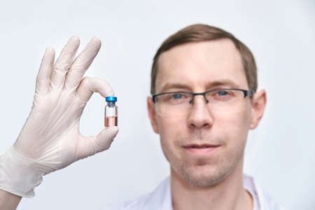 Doctor hand hold medicine vaccine. Anti virus health treatment. Medical nurse surgical. Pharmacy laboratory. Research center. Covid concept. Safety anaesthetist procedure.の写真素材