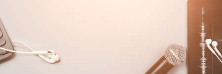 Podcast record. Microphone, headphone and sound track at tablet. Grey monochrome. Audiobook and podcasting. Audio technology. Home school teaching. Edit episode. Copyspaceの写真素材