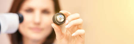 Eye doctor diagnostic. Patient at medical clinic. Cataract ophthalmology exam. Astigmatism examination. Prevention eyecare consultation. Patient control glaucoma. Horizontal banner with copyspaceの写真素材