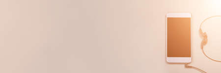 Podcast concept. Phone and earphones. Grey background. Music top view. Audio technology. Hipster lifestyle. Mockup black screen. Digital culture. School homework. Lockdown accessoryの写真素材