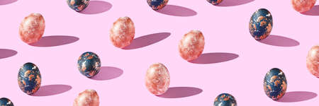 Many different eggs. Happy easter banner. Flatlay pattern. Above view. Creative trend decoration. Bright colored cover. Set of colorful food. Spring background. Pink, blue, gold. Horizontalの写真素材