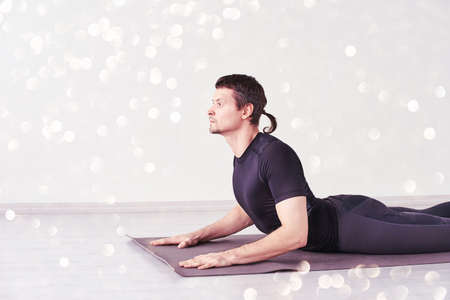 Man in yoga asana. Home lockdown studio. One person. Gym fitness. Morning meditating exercise. sport...