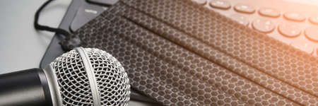 Podcast record. Protective face mask. Microphone at tablet. Grey monochrome. Audiobook and...