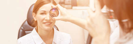 ophthalmologist doctor in exam optician laboratory with female patient. Eye care medical diagnostic....