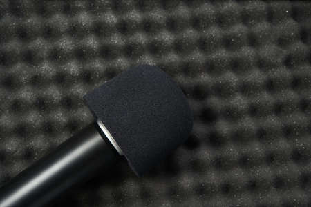 Podcast record at studio. Microphone at protection background. Record audio track equipment. Digital marketing. Broadcast. Homework study. Speech sound device. Blackの写真素材