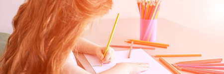 Little girl drawing. Closed Locking Exercise. Homemade routine. School lessons. Write pencil on...