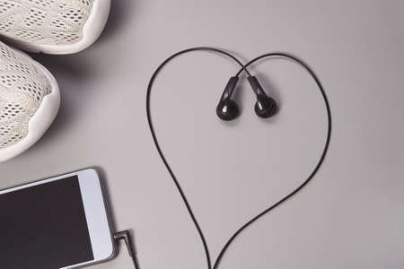 Smartphone and headphones. Podcast concept. Sport life. Heart shapeの写真素材