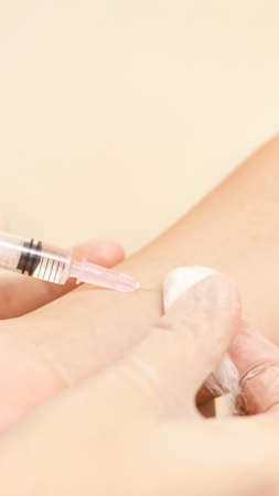 Doctor set injection to young pretty girl. Kid vaccine medical immunization. Cotton and syringe neat child arm. Medical hand. medicine pediatrician clinic. Sick baby. Copyspaceの写真素材