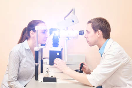 ophthalmologist doctor in exam optician laboratory with male patient. Men eye care medical...