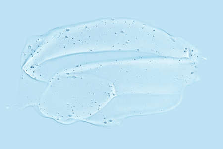 Texture transparent gel. Serum skincare product. Moisturizer jelly hair conditioner. Emulsion cosmetics. Sanitizer smear. Copyspace. Hyaluronic face fluid. Water wave cream. Blue monochromeの写真素材