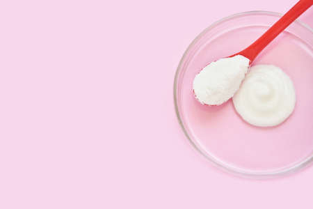 Collagen white powder. Pastel color background. Health product. Woman cosmetics concept. Sport...