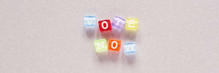 Vote now slogan on Grey background