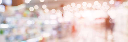 Empty blurry mall background. DeFocused wallpaper. Business office interior. Light lifestyle supermarket. Bokeh effect. Holiday backdrop. Copyspace for text. Ready for card or site designの写真素材