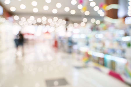 Empty blurry mall background. DeFocused wallpaper. Business office interior. Light lifestyle supermarket. Bokeh effect. Holiday backdrop. Copyspace for text. Ready for card or site designの写真素材