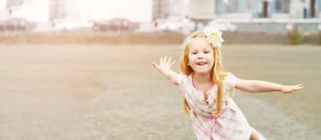 Baby girl funny posing. Outdoors female portrait. High quality photo. Autumn city activity....