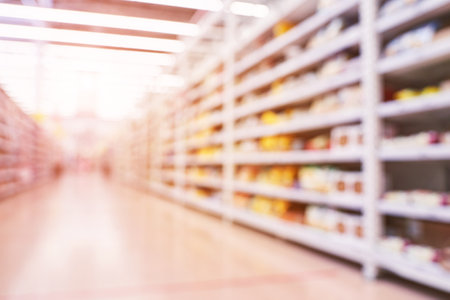 Food market interior. Blur corridor light background. Shop shelf. Stock cold goods. Refrigerator milk storage. Perspective grocery hall. Supermarket wallpaper. Copyspace.の写真素材