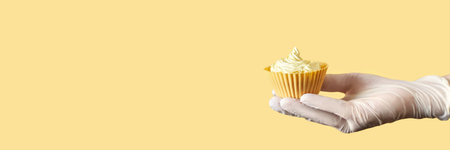 Yellow monochrome bakery. Sustainable cupcake cup. Hold in hand. Gold maffin cream. Trendy colourful...