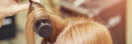 Long hair woman. Hairdresser treatment. Repair procedure. Haircut at salon. Bride hairstyle. Master hand with brush. Adult female person. Closeup view. Lady preparation. Blonde dry. Banner, copyspaceの写真素材