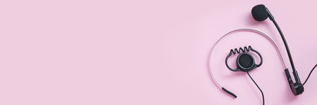 Translation center. Set for telemarketing. Manager customer. Listening operator. Flatlay. Person multi language translator. Pink color background. Multy guide. Speakers device. Conference equipmentの写真素材