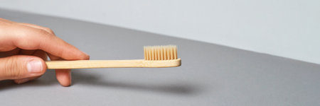Hand holding toothbrush. Bamboo eco brush. Dental sustainable concept. Layout. Morning home routine....