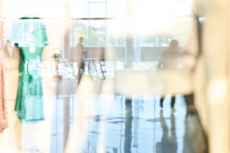 Empty blurry mall background. Defocused wallpaper. Business office interior. Light lifestyle supermarket. Bokeh effect. Holiday backdrop. Copyspace for text. Ready for card or site designの写真素材