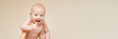 Cute small boy at mother hands. Childhood concept. Smiling child. Happy emotion. Copyspace. Stay...
