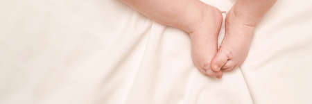 Little child feet. Toddler legs. Baby person. Tiny health care. White children. Massage concept....