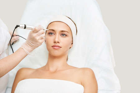 Permanent makeup. Beauty spa procedure. young woman. Face tattoo. Eyeliner micropigmentation....