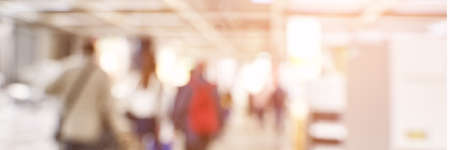 Blurry people at shop store. Defocused mall interior bakground. Crowd business retail market. Franchise backdrop. Copyspace. Exhibition view. Horizontal bannerの写真素材