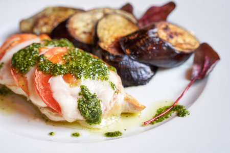 Summer healthy food. Cheese, tomato, basil, eggplant reciepe. Mozzarella sliced oven. Homemade dinner. Cafe italian meal. Diet cooked lunch.の写真素材