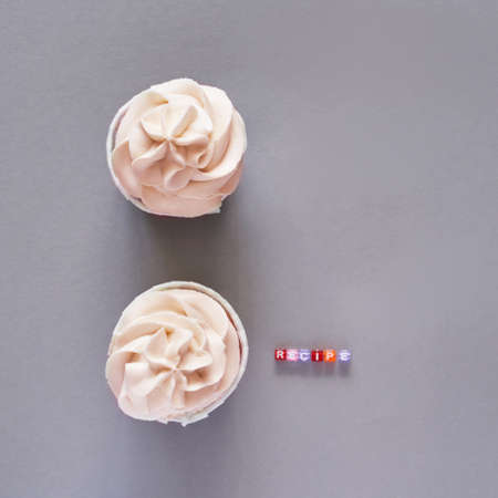 Milky cream cupcake. Birthday sweet bakery. Cookies. Yummy buttercream dessert. Wedding party food. Grey background. Holiday recipe. Anniversary gourmet quote. Two piecesの写真素材