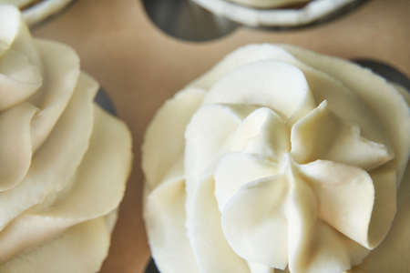 Paper box with cream cupcake. Birthday sweet bakery. Cookies two pack. Yummy buttercream dessert. Wedding party food. Grey background. Holiday recipeの写真素材