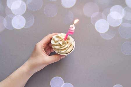 Milky cream cupcake. Birthday sweet bakery. Cookies. Yummy buttercream dessert. Wedding party food. Grey background. Holiday recipe. Anniversary gourmet. One pieces. Candle lightの写真素材