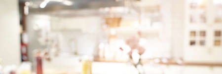 Kitchen blur background. Home indoor room interior. Modern cooking area. Empty coffee shop. Business bakey shop. Light bokeh view. Architecture backdrop. Horizontal bannerの写真素材