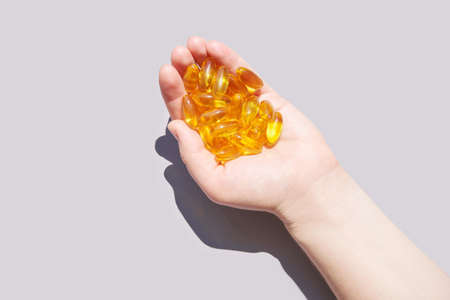 Hand with Omega3 gel capsules