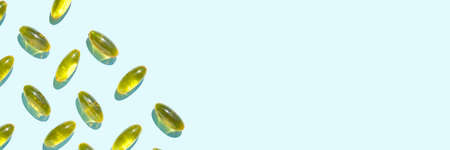 Omega3 gel capsule. Sun shadow. Yellow vitamin. Health eating. Dietology drug. Fish oil supplement. Nutritional concept. Golden softgel collagen. Medicine immunity cosmeticsの写真素材