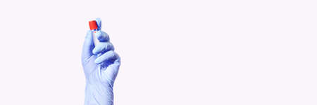 Corona test tube. Lab equipment. Healthcae concept. Chemistry science development. Medical device. Transparent glass. Hand in glove holding resultの写真素材