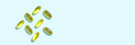 Omega3 gel capsule. Sun shadow. Yellow vitamin. Health eating. Dietology drug. Fish oil supplement. Nutritional concept. Golden softgel collagen. Medicine immunity cosmeticsの写真素材