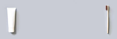 Ecology toothbrush on grey background. Brush on table. Sustainable mouth product. Zero waste lifestyle. Organic accessory. Dental health at home. Biodegradable recycle. Toothpasteの写真素材