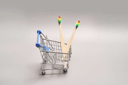 Set of ecology toothbrush on grey background. Different color at shop cart. Diversity concept. Sustainable mouth product. Zero waste lifestyle. Organic accessory group. Biodegradable recycleの写真素材