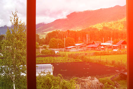 Holistay house. Countryside hiking. Window view. Vacation landscape. Russian Altai mountains....